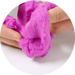 Gif of pink Kinetic Sand flowing